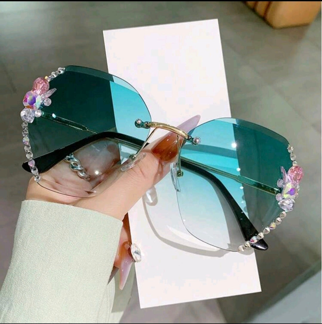 Green sunglasses with decorative rhinestones